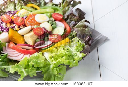 fresh mix vegetation salad on white wood background, concept diet and healthy food
