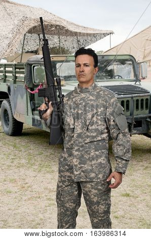Handsome young man soldier with a rifle