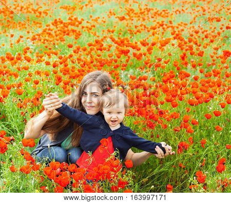 Field of flowers. Mom poses with her daughter