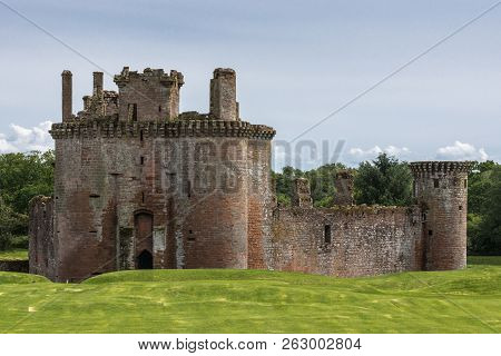 Shearington, Scotland, Uk - June 18, 2012: Closeup Of Ruined  Triangular Brown Stone Moated Caerlava
