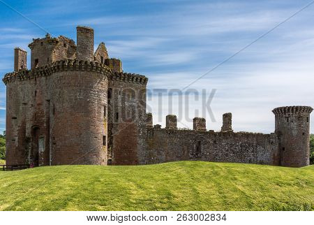Shearington, Scotland, Uk - June 18, 2012: West Side Of Ruined  Triangular Brown Stone Moated Caerla