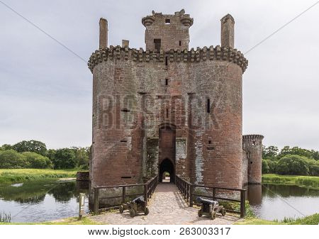 Shearington, Scotland, Uk - June 18, 2012: Entrance Tower To Ruined  Triangular Brown Stone Moated C