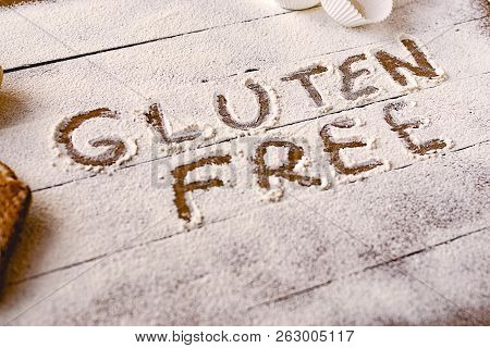 Gluten Free Concept. Wooden Table With Flour And Pastry Material, With The Written Phrase Gluten Fre