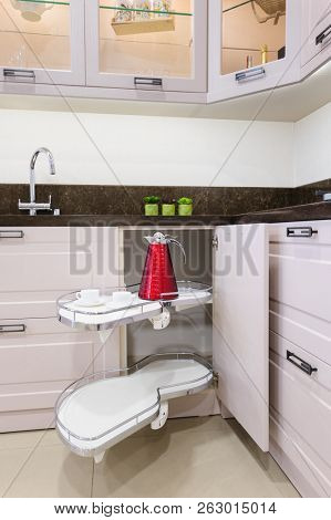 Kitchen corner storage unit with pullout shelves for cookware.