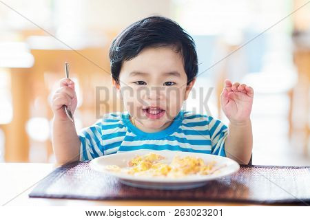 Asian Baby Eating A Breakfast And Smiling On A Table, This Immage Can Use For Food, Healthy, Kid, Bo