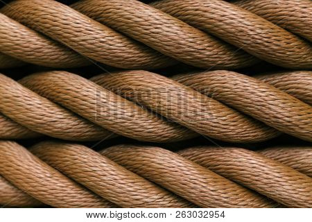 Thick Brown Rope Rolled Into A Roll. Horizontal Layout. Background Texture