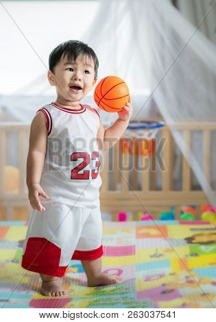 Baby With Ball In Basketball Uniform, This Immage Can Use For Play, Sport, Baby, Child, Kid And Exer