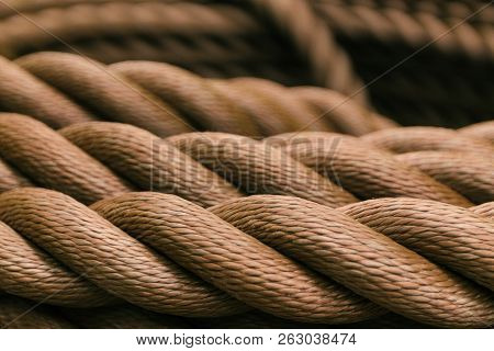 Thick Brown Rope Rolled Into A Roll. Background Texture