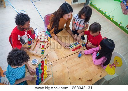 Teacher And Student In An International Preschool Play A Toy Togather, This Concept Can Use For Educ