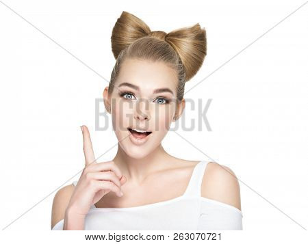 Young woman with an idea. Girl pointing finger up. Idea concept.
