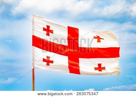 Beautiful View To Waving Flag Of Georgia On The Georgian Military Road Against The Background Of The