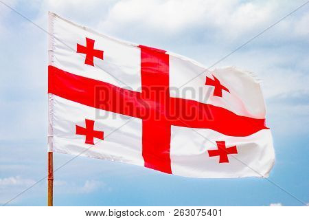 Beautiful View To Waving Flag Of Georgia On The Georgian Military Road Against The Background Of The