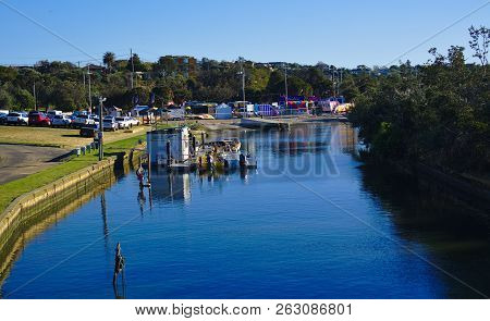 Frankston, Vic / Australia - Oct 13 2018: View Of Blue River With Boat Hire Dock On Sunny Day With B