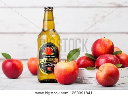 London, Uk - September 13, 2018: Bottle Of Kopparberg Sweet Apple Cider With Fresh Apples On Wood Ba