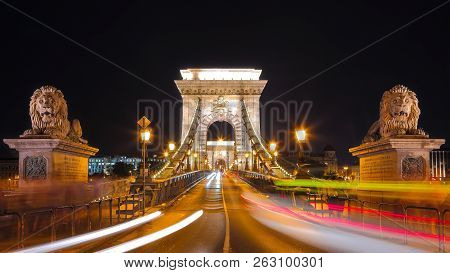 Traffic On Széchenyi Chain Bridge Over Danube River, Budapest City, Hungary. Night Scene