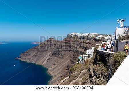 Santorini, Greece - August 2018: People Are Walking Along Cliffs Of Island.
