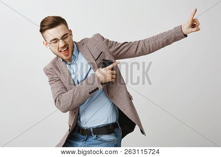Boosting Mood And Confidence With Right Track. Delighted Good-looking Joyful Man With Bristle In Tre