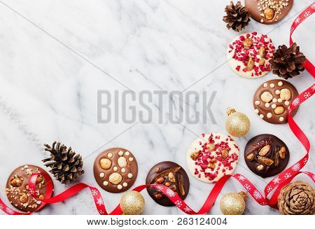 Chocolate Mediants With Christmas Ribbon. Marble Background. Copy Space. Top View