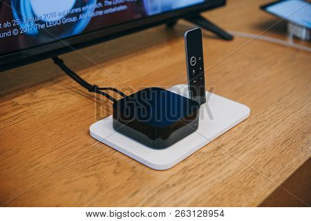 Berlin, August 29, 2018: Apple Tv Device And Remote Control Or Joystick. Modern Devices For Televisi