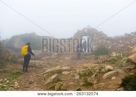 Backpackers On Foggy Trekking Path In Annapurna Conservation Area, Nepal