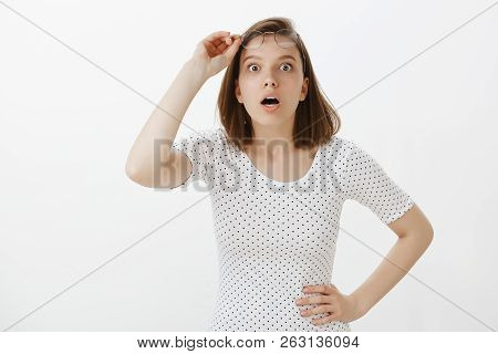 No Way. Portrait Of Shocked And Stunned Good-looking Girl, Holding Hand On Hip, Taking Off Glasses, 