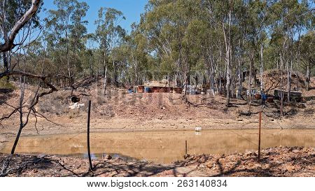 Sapphire Diggings Beside A Dam In Central Australia