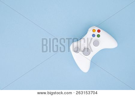 White Joystick Is Isolated On A Pastel Blue Background. Video Game. Gaming Concept. Copyspace. Flayl
