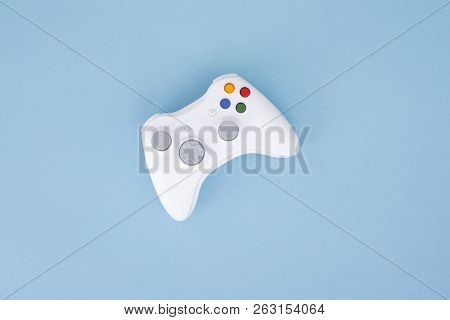 White Joystick Is Isolated On A Pastel Blue Background. Video Game. Gaming Concept. Copyspace. Flayl