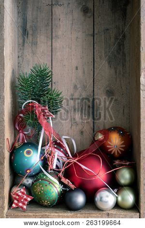 Christmas decoration glass balls with twigg in a wooden box background