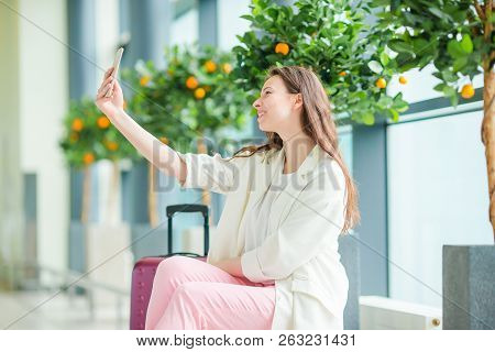 Beautiful Woman In International Airport. Tourist With Smartphone Indoor