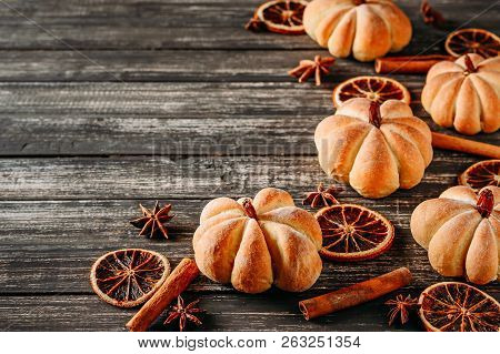 Homemade Cakes In Shape Of Pumpkin And Dried Oranges On Dark Wooden Backgroundm Top View With Copy S