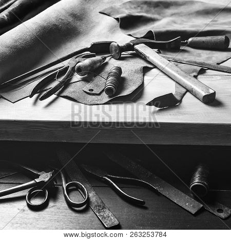 Old Tools At Table. Pieces Of Leather At Cobbler Workplace. Shoemaker's Work Desk. Leather Craft Too