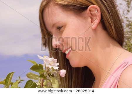 Young Woman holding a Bunch of Apfel Blüten.