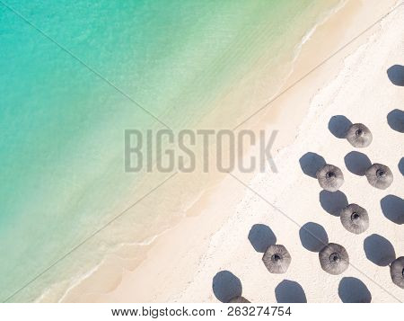 Aerial View Of Amazing Tropical White Sandy Beach With Palm Leaves Umbrellas And Turquoise Sea.