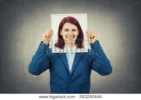 Man Covering His Face Using A Woman Portrait, Like A Mask For Hiding His Identity. Business Undercov