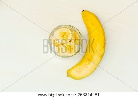 Sliced ​​banana In The Glass With Banana On The Side