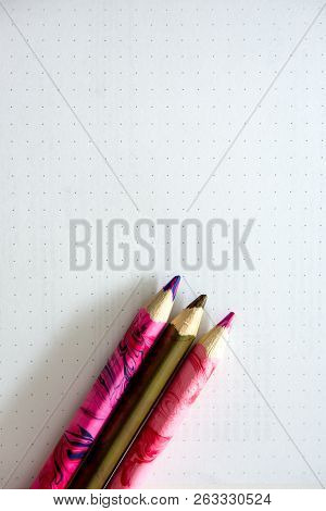 Colored Pencils Are On The School Notebook. Notebook Lies On The Desk At School. The Kids Are Learni