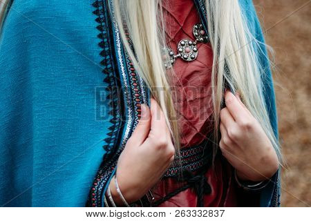Girl With Long Hair, Blonde, Holding A Cape In Her Pink Dress.celts