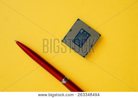 The Processor For Socket Lga 1151 And A Pen On A Yellow Background. Computer Techologies.