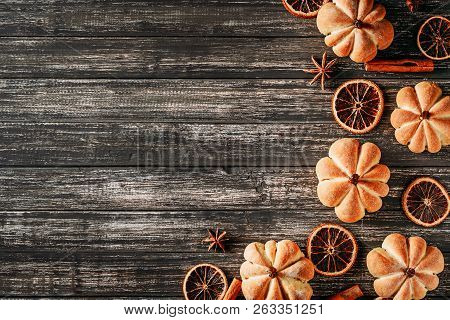 Homemade Cakes In Shape Of Pumpkin And Dried Oranges On Dark Wooden Backgroundm Top View With Copy S