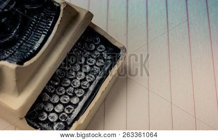 Retro Syled Tiny Typewriter Model On A Paper Background
