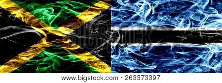 Jamaica Vs Botswana, Botswanan Smoke Flags Placed Side By Side. Thick Colored Silky Smoke Flags Of J