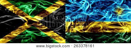 Jamaica Vs Rwanda, Rwandan Smoke Flags Placed Side By Side. Thick Colored Silky Smoke Flags Of Jamai