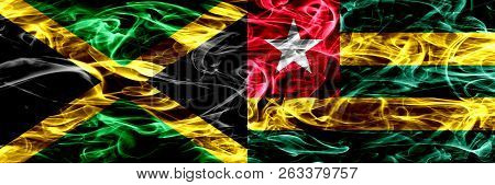 Jamaica Vs Togo, Togolese Smoke Flags Placed Side By Side. Thick Colored Silky Smoke Flags Of Jamaic