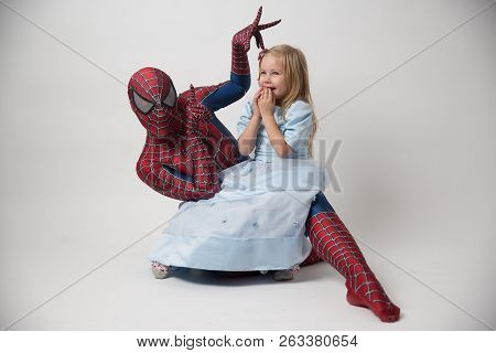 Israel, Tel Aviv October 14, 2018. The Spiderman Is Holding A Little Girl In His Arms. A Man In A Sp