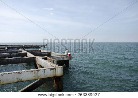 Thai Angler Or Fisherman Use Fishing-rod Fishing Fish In The Sea At Coast Of Laem Thaen Cape And Sce