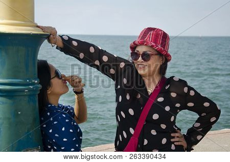 Thai People Travel And Visit Sculpture Of Dolphins On The Waves Monument In Chonburi, Thailand