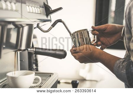 Barista Using Coffeemaker Extraction For Espresso Shot And Steam Milk In Cafe.