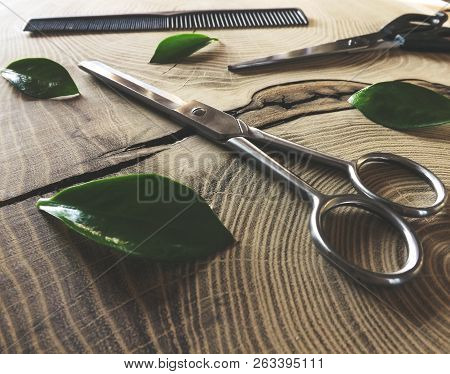 Shiny Scissors On Wooden Background. Modern Hairdressing