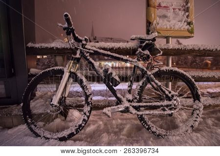 end of biking season.parked bicycle covered by snow from a heavy snowstorm.Winter cycling
